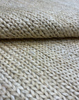 Close-up view of the texture and weave of Ziegler & Co. Modern Rug in light beige, showcasing its intricate braid pattern.