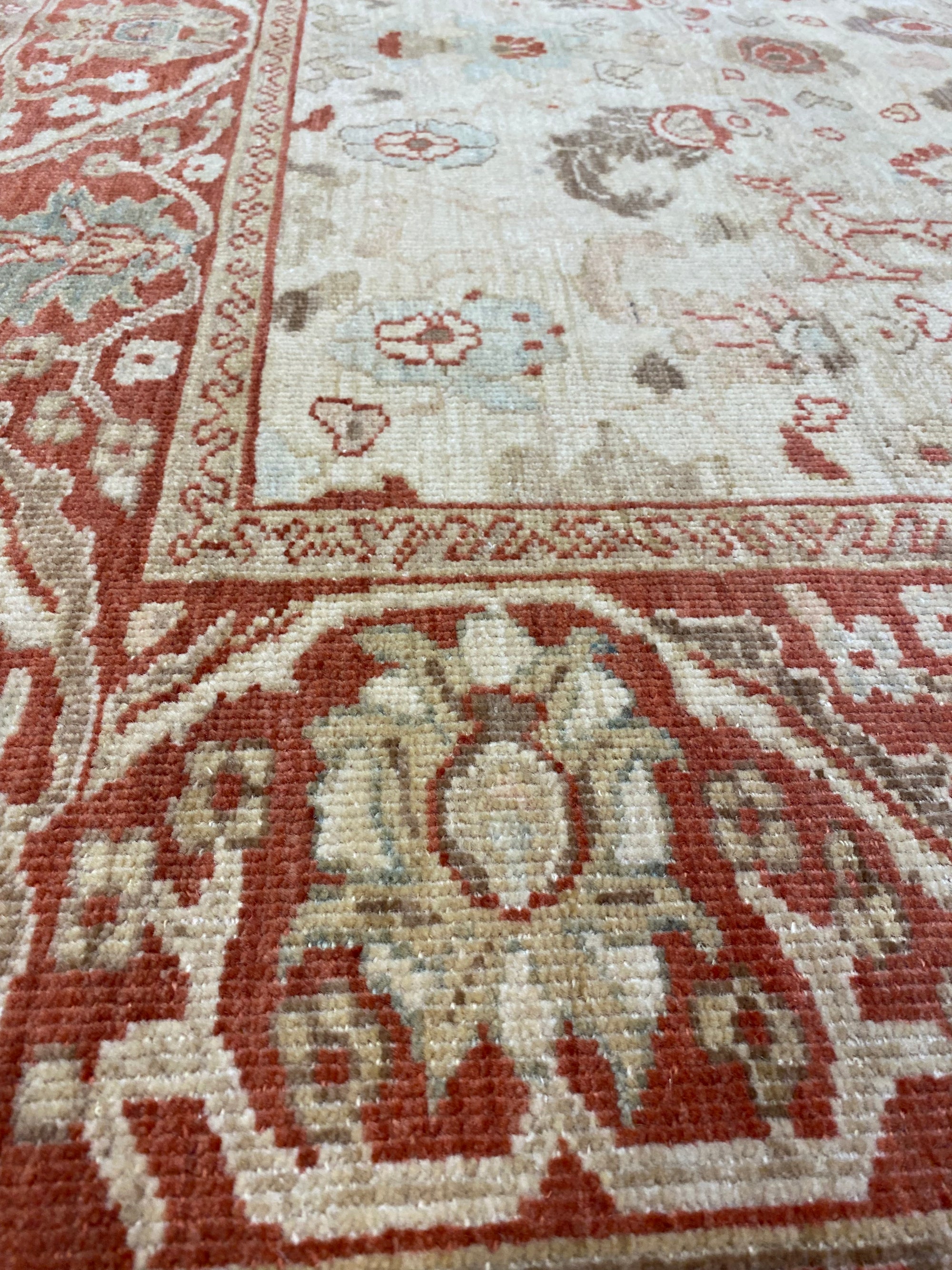 Close-up of Original Ziegler & Co. Sultanabad rug, showcasing intricate floral patterns in red, beige, and soft blue tones.