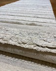Close-up view of Ziegler & Co Montecito Vibe Runner, showcasing detailed texture and patterns in a light-colored fabric.