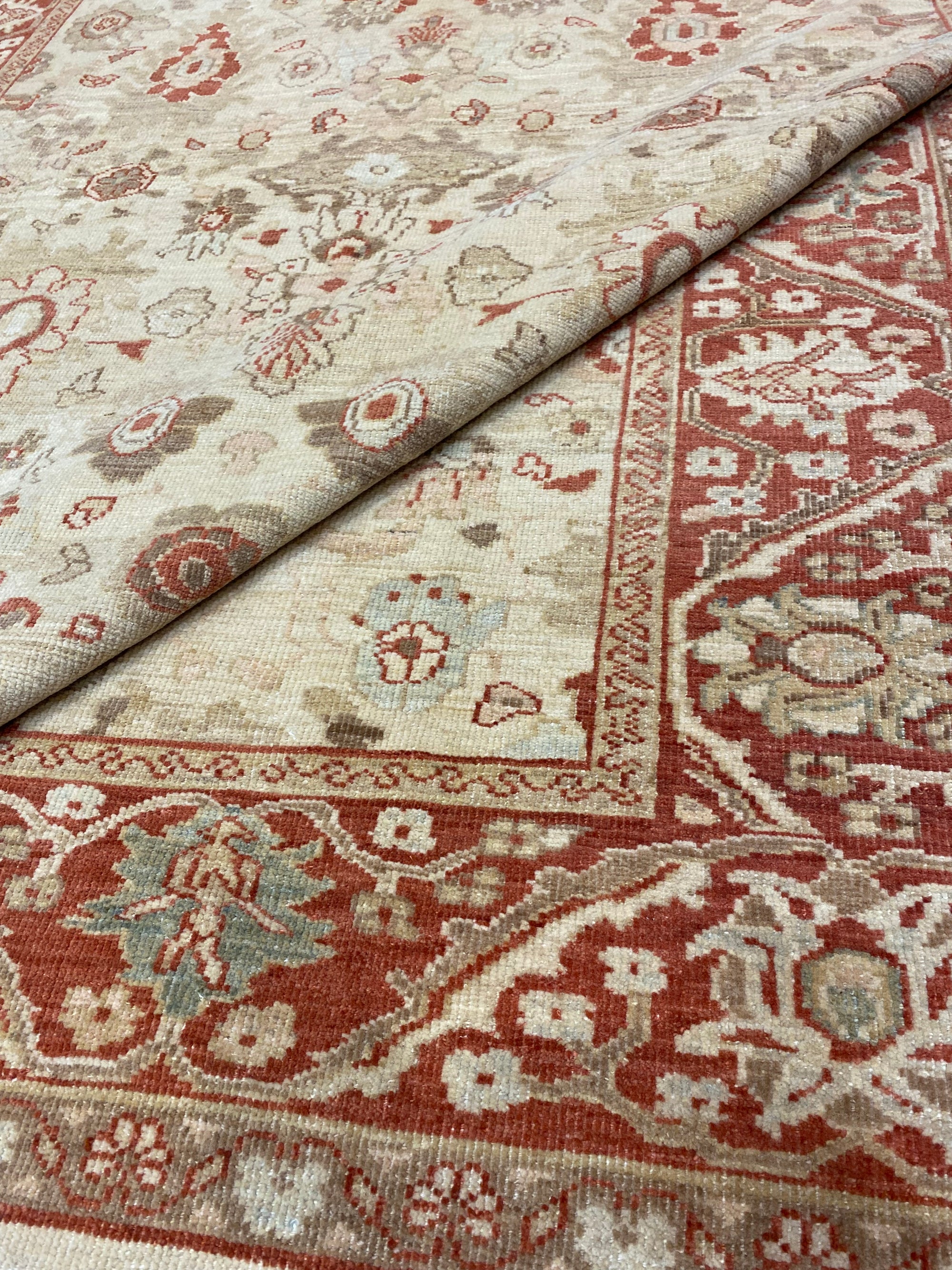 Close-up view of an Original Ziegler & Co. Sultanabad rug featuring intricate floral patterns in beige and red tones.
