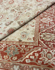 Close-up view of an Original Ziegler & Co. Sultanabad rug featuring intricate floral patterns in beige and red tones.