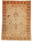 Vintage Angora Oushak rug with intricate patterns in muted red and beige tones, featuring a classic floral border design.