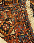 An antique Persian Afshar rug featuring a diamond pattern. A piece of genuine original woven carpet art sold by the Santa Barbara Design Center.