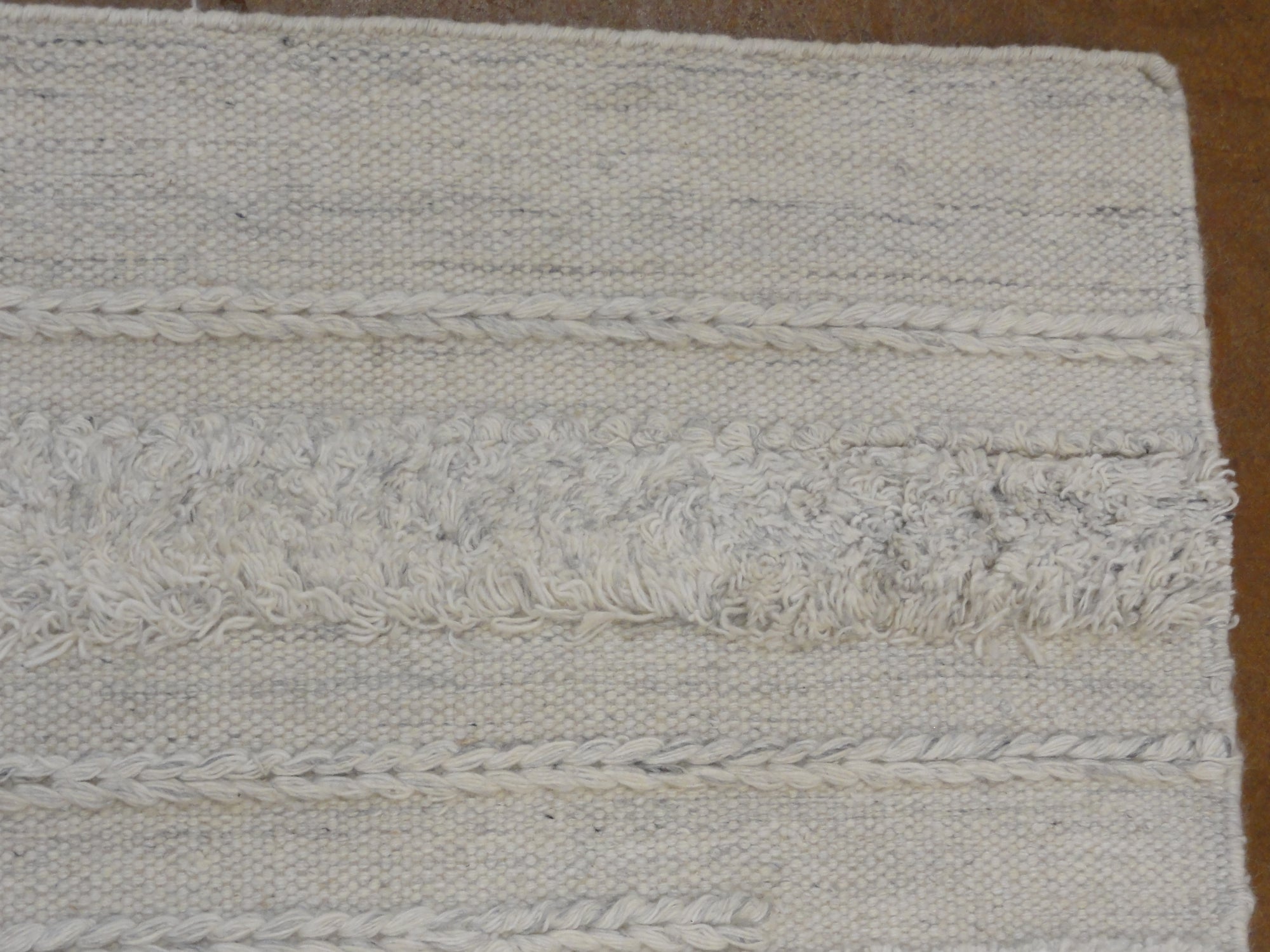 Close-up view of Ziegler & Co Montecito Vibe rug, showcasing its texture and intricate woven patterns in neutral tones.