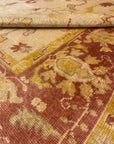 Close-up of Vintage Angora Oushak rug showcasing intricate floral patterns in muted earthy tones.