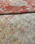Folded to show texture, density, pattern, of Antique Khotan Rug