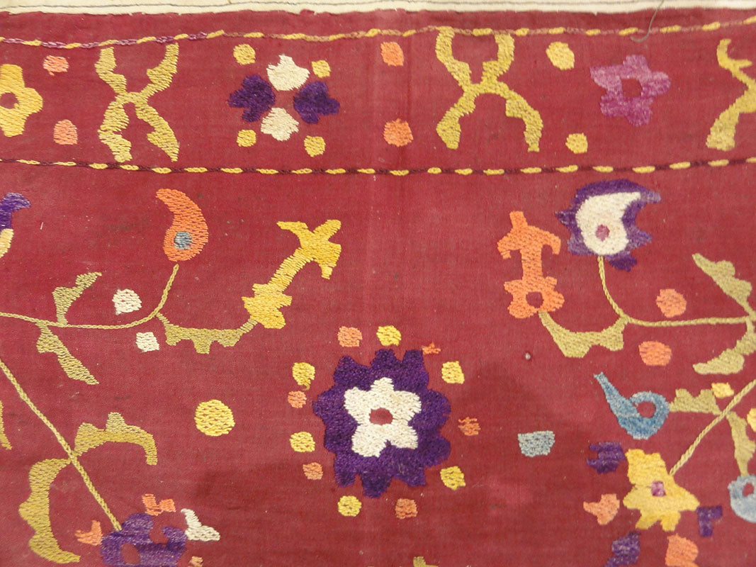 Antique Uzbek Turkestan Wool and Silk Suzani. A piece of wool and silk woven art sold by Santa Barbara Design Center Rugs and More in Santa Barbara CA.