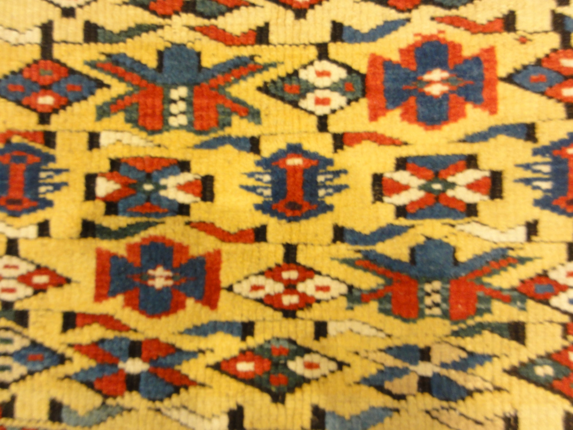 Antique Rare Gold Kuba Chichi Rug. A genuine authentic antique piece of carpet art sold by the Santa Barbara Design Center, Rugs and More.