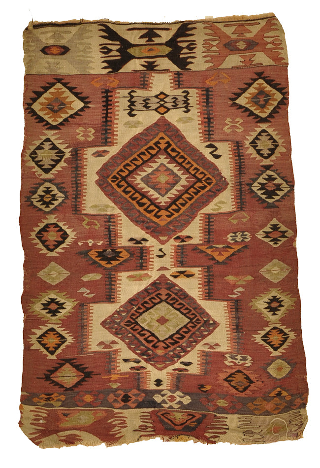 kilims feature muted colors and thin textures to allow the picture itself to stand out as the most noticeable feature on the rug’s surface. Warm colors are often used as the primary hues throughout, though many kilims tend to balance the landscape by also applying cooler tones, which help create points of contrast that entice the viewer’s responsiveness. 2'8 x 4'2