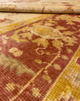 Close-up of a Vintage Angora Oushak rug, showcasing intricate patterns with earthy tones of red, yellow, and beige.