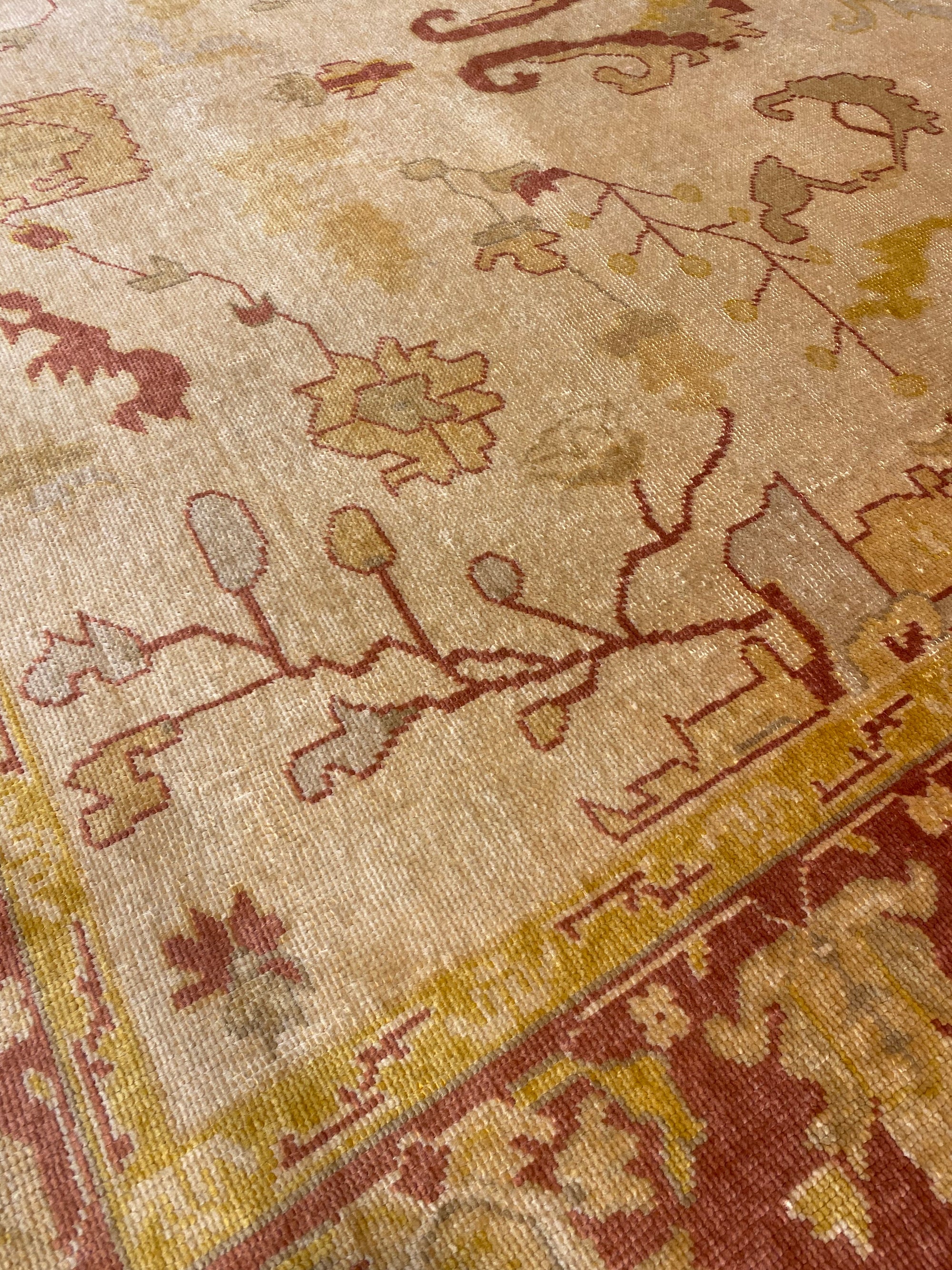 Close-up of Vintage Angora Oushak rug featuring intricate floral and geometric patterns in earthy tones.