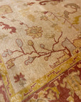 Close-up of Vintage Angora Oushak rug featuring intricate floral and geometric patterns in earthy tones.