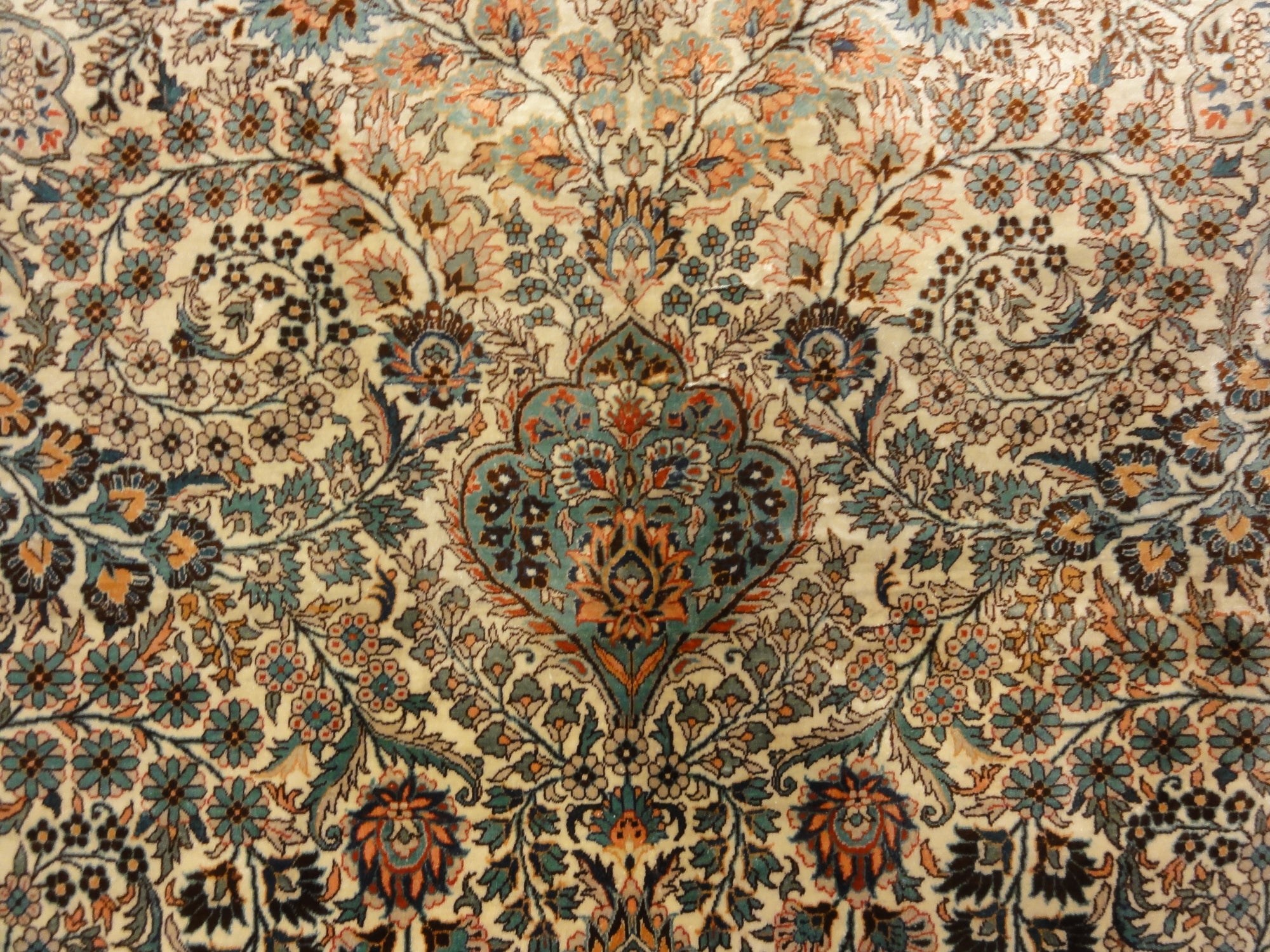 An antique finest silk rug featuring the garden of paradise with 1001 flowers. A piece of genuine woven carpet art sold at Santa Barbara Design Center.