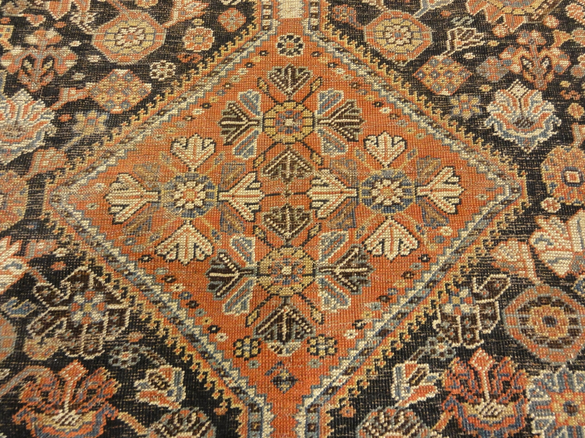 Antique Persian Qashqai featuring Tribal Flowers. A piece of genuine handwoven carpet art sold by Santa Barbara Design Center Rugs and More.