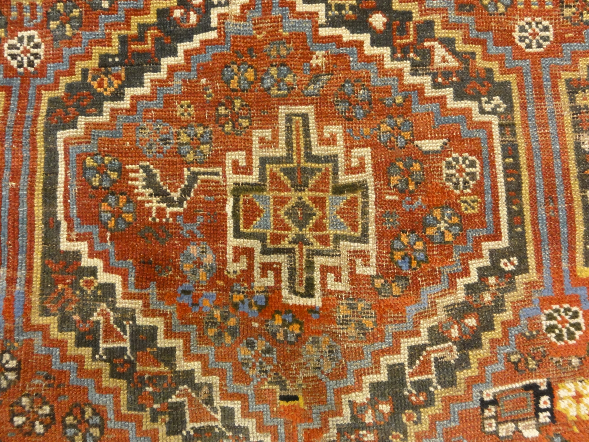 Antique Persian Khamseh Chicken Rug. A piece of genuine woven carpet art sold by Santa Barbara Design Center Rugs and More.