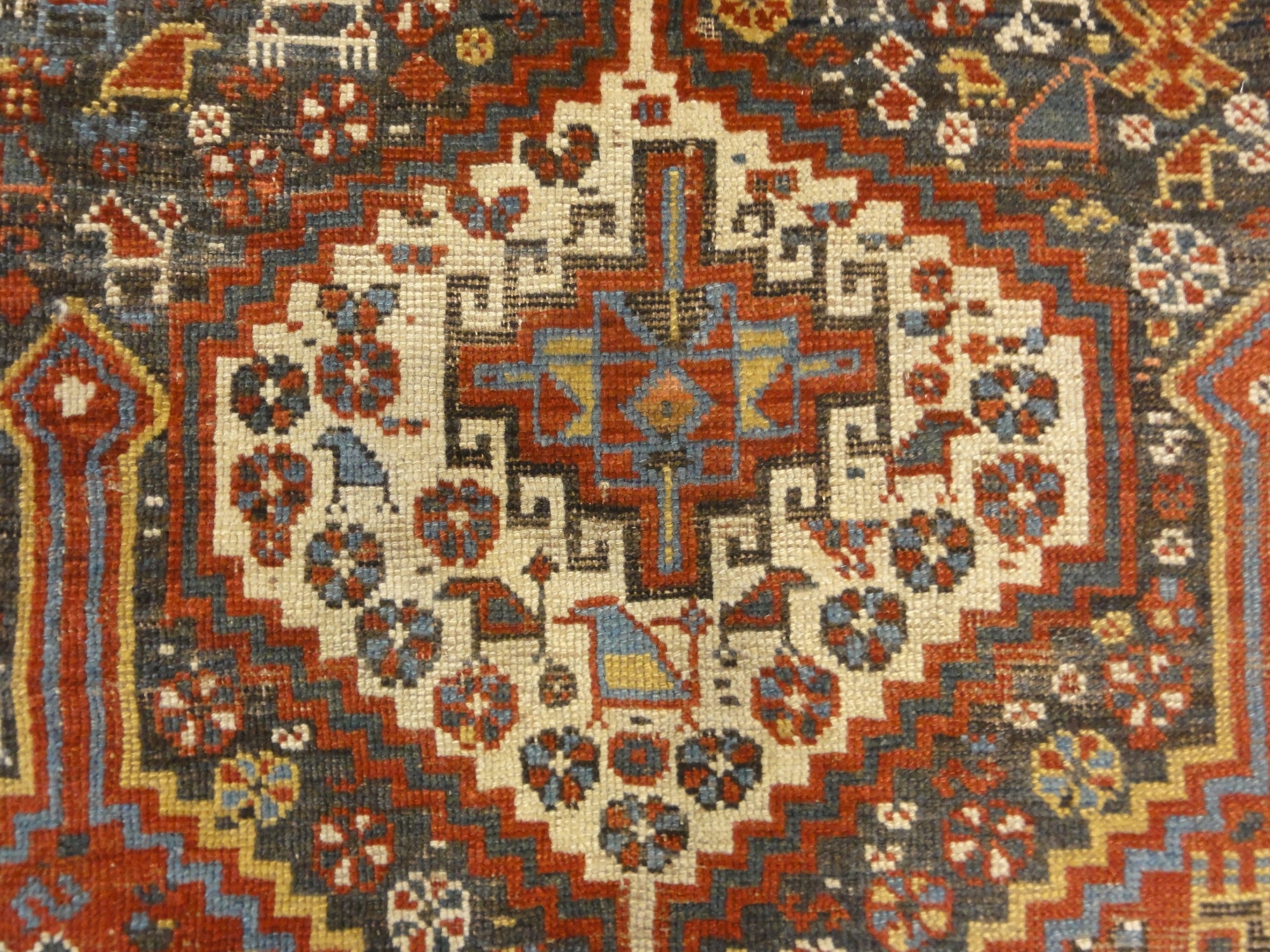 Antique Persian Khamseh Chicken Rug. A piece of genuine woven carpet art sold by Santa Barbara Design Center Rugs and More.